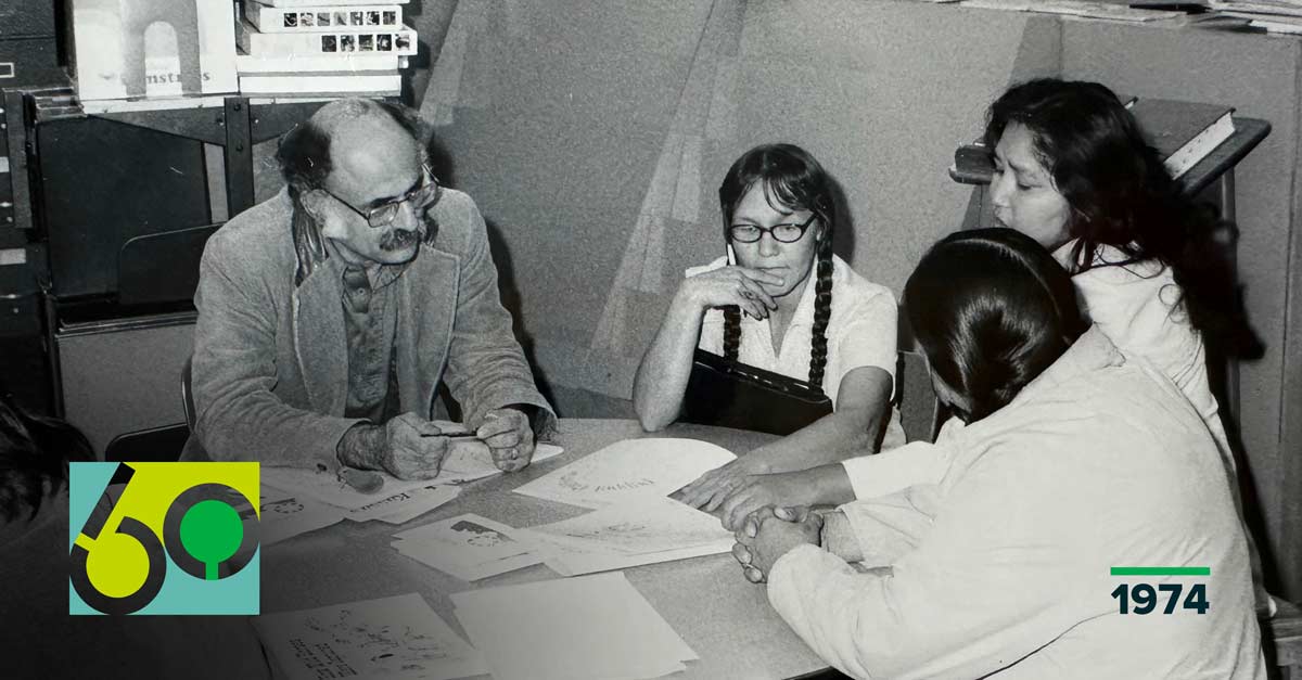 four people meeting together around a table