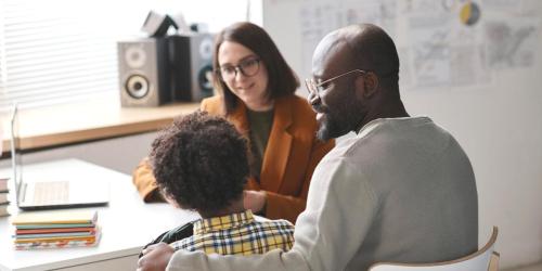 teacher talking to a parent and student